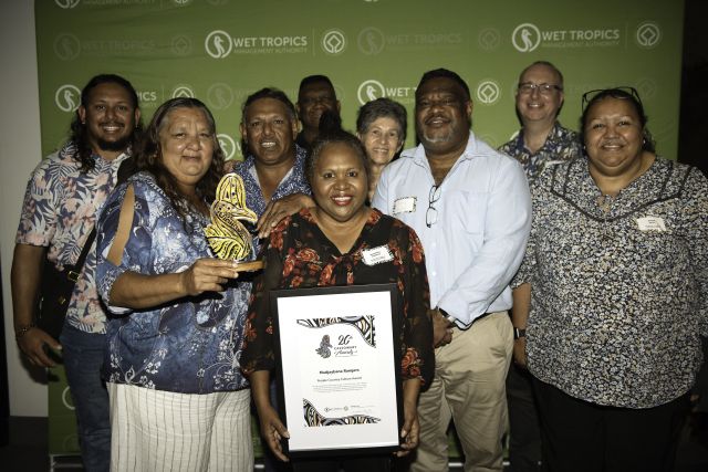 Group of Indigenous people standing with an award and a certificate.